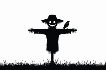 Fototapeta premium Black silhouette of a scary scarecrow with a wide grinning face and a straw hat standing in a field with a crow perched on its arm isolated on a white background