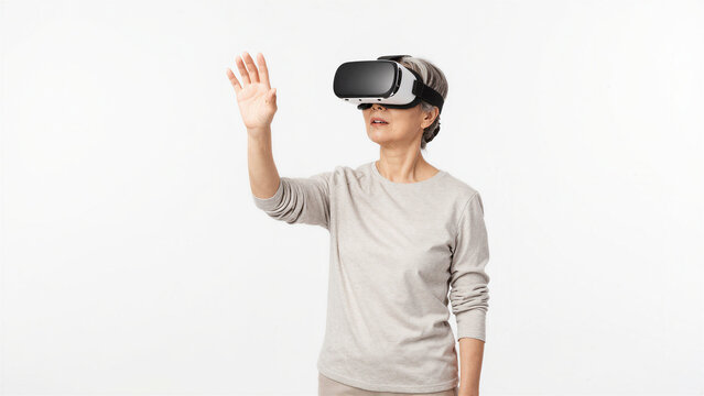 Japanese Senior Woman Experiencing Virtual Reality and Reaching Forward on White Background, Copy space on the left