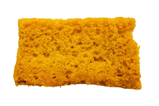 A golden cake rusk highlighting its porous baked sponge texture on a clean background