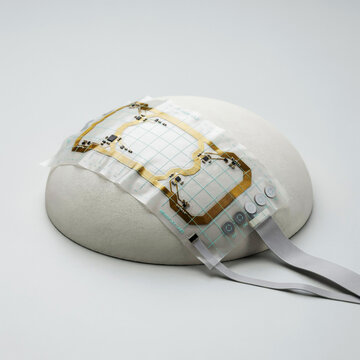 Flexible electronic circuit on a curved surface, representing wearable technology electronics