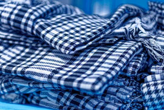 Traditional Blue and White Plaid Cotton Scarves Stacked in Shop