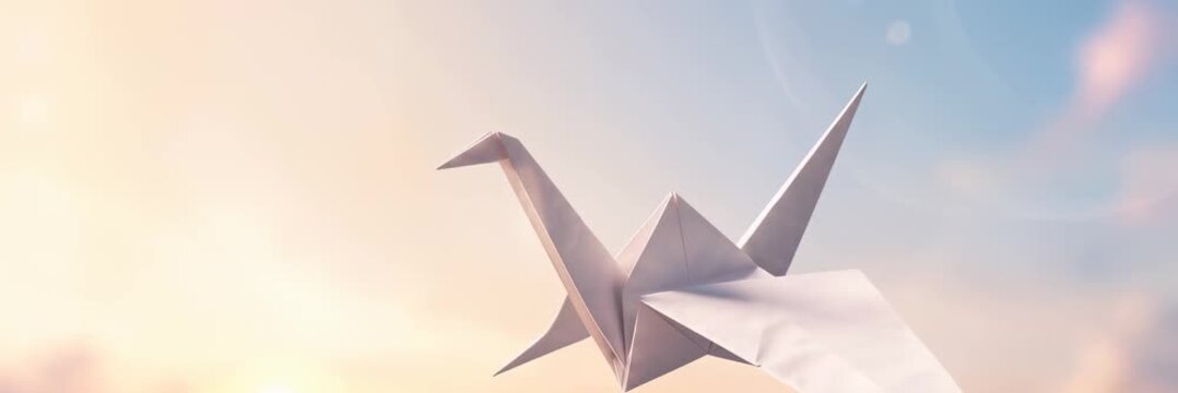 White origami crane against soft pastel sky symbolizes peace and hope with copy space website banner