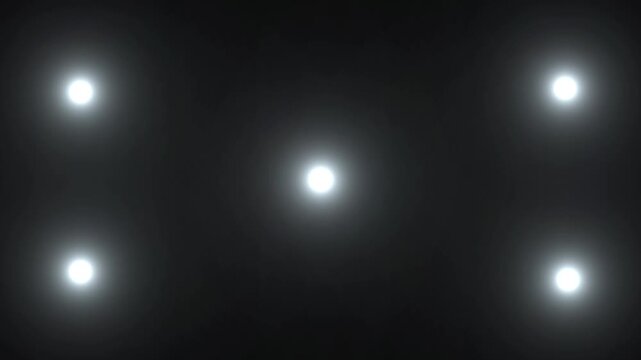Five bright glowing light spots video arranged in a pentagon pattern on a dark black background, abstract digital light effect with soft lens flare video