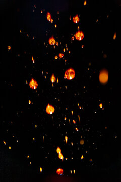 Macro photo of fire sparks bokeh texture on black background