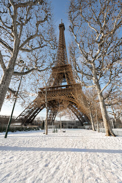 Eiffel tower in paris covered in winter snow