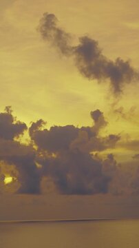 Golden Sunset Over Ocean with Dramatic Cloudscape Silhouette