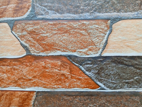 Decorative stone cladding wall with rectangular tan and brown slate tiles stone texture wall panel