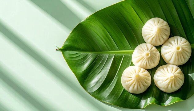 Fresh Steamed Asian Dumplings Served on a Large Green Banana Leaf