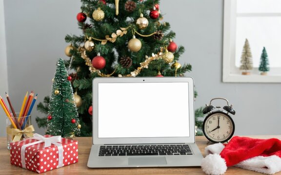 Christmas workspace with laptop, gift and decorations