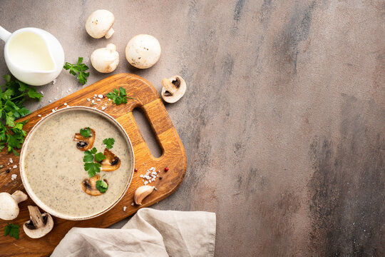 Mushroom soup puree on white kitchen table.