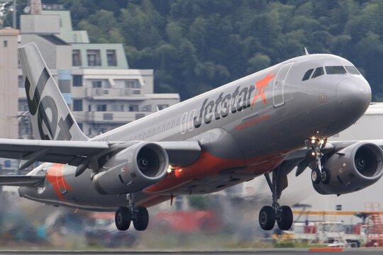 A Jetstar Japan Airbus A320 takes off over the city on October 26, 2016 in Japan.