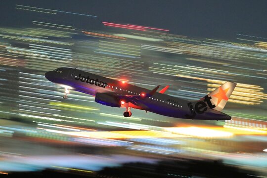 A Jetstar Japan Airbus A320 takes off at night captured with motion blur on October 11, 2016 in Japan.