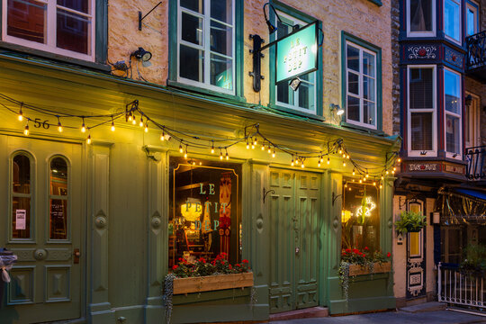 Quebec City, Quebec, Canada, September 6, 2026 - The illuminated green facade of the caf&eacute; and small high end grocery store Le Petit Dep at 52 Sous-le-Fort Street in the old town seen before dawn