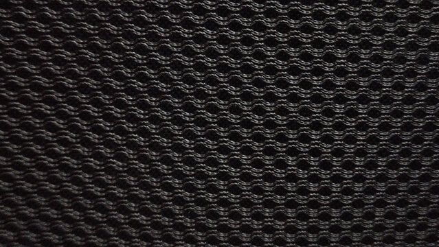 Black synthetic wrap knitted mesh textured fabric geometric pattern background