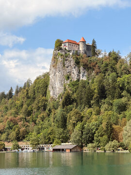 Bled Castle on cliff overlooking Lake Bled, Slovenia, scenic medieval fortress with mountain views