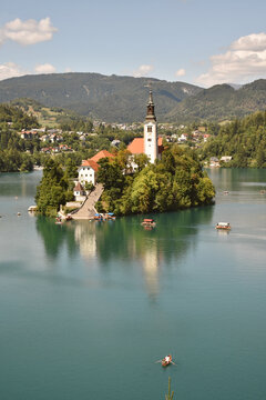 Scenic view of Lake Bled in Slovenia with island church, surrounded by mountains and calm turquoise water