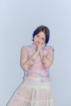 Portrait of a stylish non-binary person with purple hair
