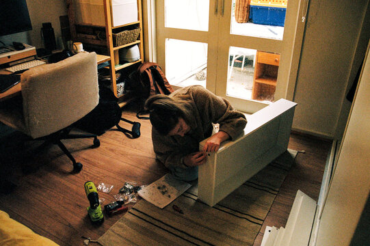 Person assembling furniture at home for a cozy space