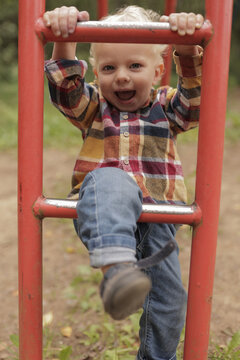 Boy laughing during backyard summer play