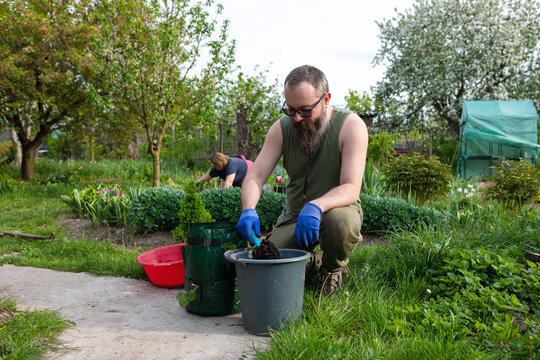 adding soil to a hanging bag