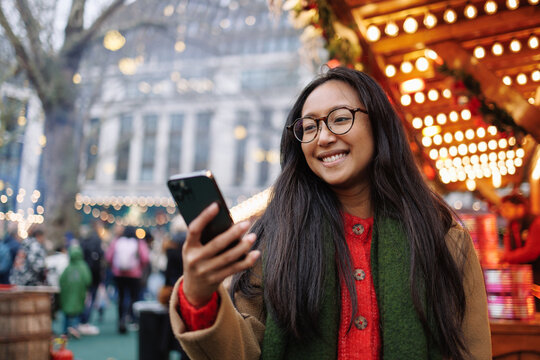 Young woman enjoying Christmas market in London