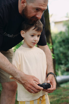 Father And Son Spend Time Together Playing With A Car
