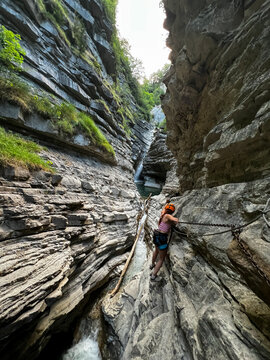 Climber Scales Rocky Canyon Walls in Summer
