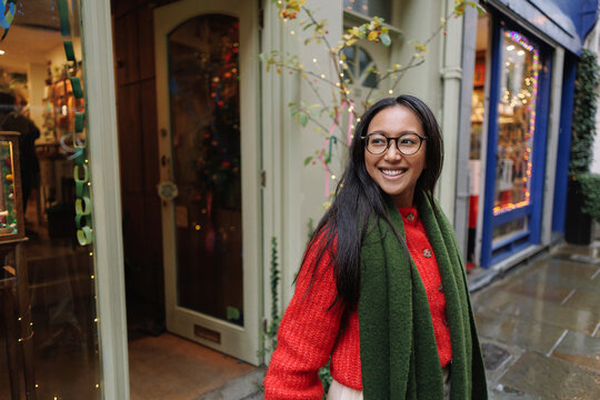 Smiling woman enjoying Christmas shopping in London