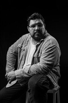 Subject wearing glasses and beard posing confidently