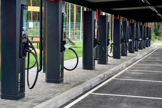 Electric vehicle charging stations lined up near a park