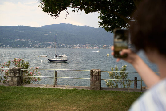 Person Takes a Picture of Boats on a Lake During the Day