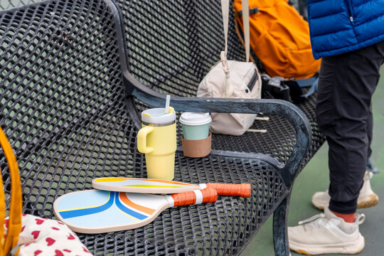 sports belongings on bench reusable water bottle pickleball
