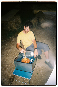 Man Cooking on a Camping Stove