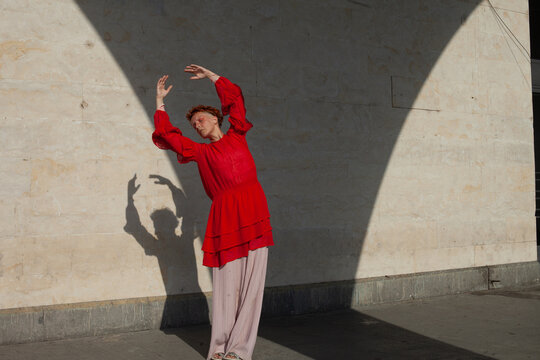 A woman in the red in the beige space