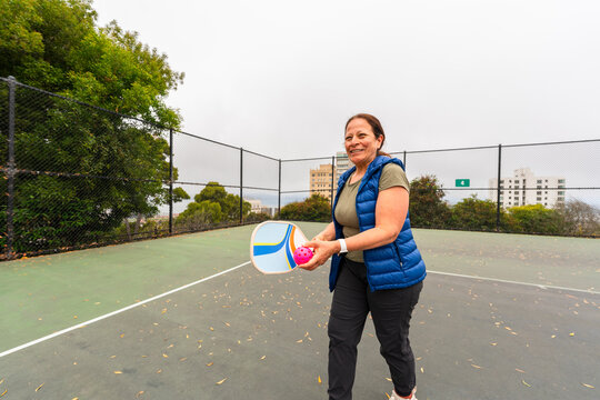 pickleball player getting ready to serve ball paddle