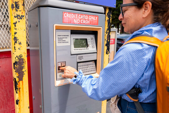 woman using credit card paying parking machine