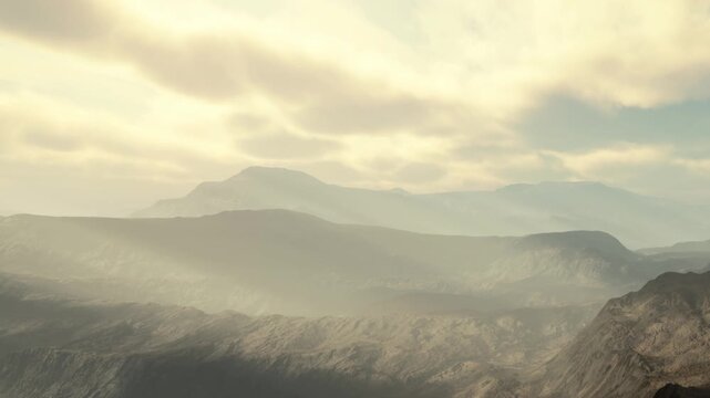 Mountains stretch across the horizon with a mix of fog and clouds in the late afternoon sky. The landscape shows elevation changes and contours under soft light.