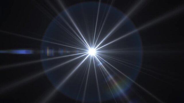 Bright lens flare radiating light beams with chromatic aberration during a cinematic camera zoom out on black
