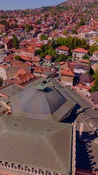 Aerial Drone Close Up View of Vijecnica Roof and Old Town Sarajevo Hills