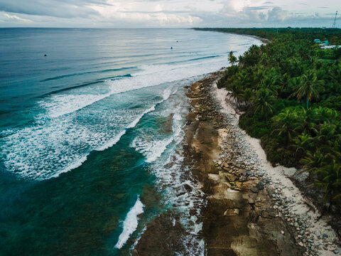 Drone view of sea with waves and coastline on Fuvahmulah island in Maldives