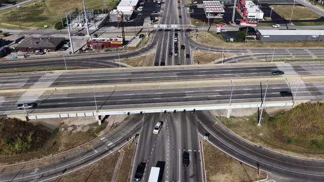 Daytime aerial highway interchange and commercial area in Springfield Missouri showing multiple lanes of traffic on the overpass and intersecting roads