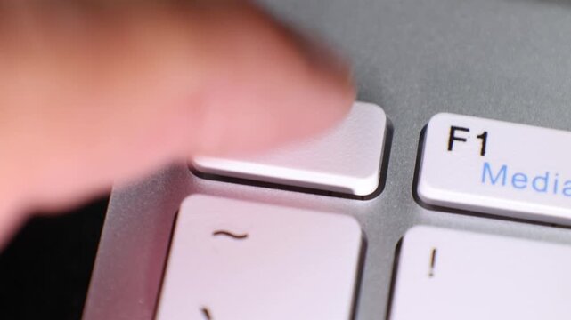 Close-up view of the Escape (Esc) key on a laptop keyboard, showcasing its position near the function keys and tilde key. The image highlights the design and labeling of the key