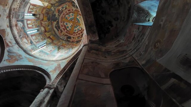 Interior of ancient orthodox monastery showcasing vibrant biblical frescoes on the dome, arches and columns - medieval georgian religious art and architecture, unesco-style heritage site