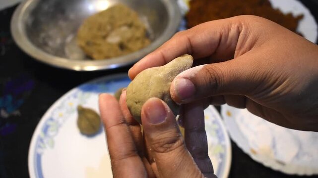 making modak with hand in Indian household kitchen technique for Ganesh Chaturthi.