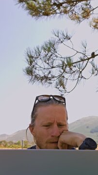 Vertical Video of Thoughtful Man Having Idea While Working on Laptop