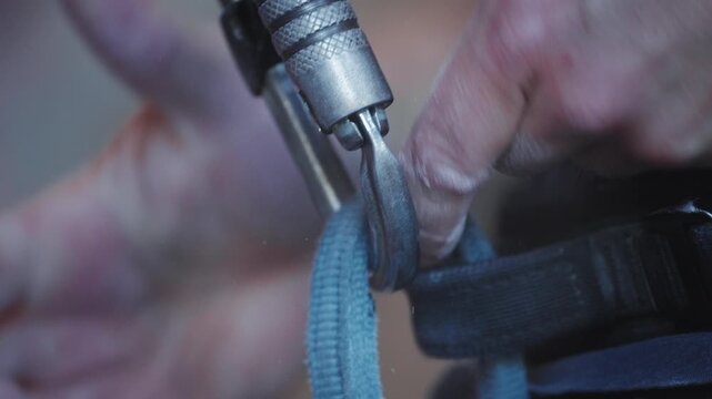 Climber Attaching Auto Belay Carabiner to Harness
