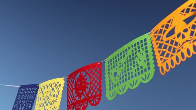 Colorful Papel Picado Banners Hung Overhead for Day of the Dead Outdoor Celebration