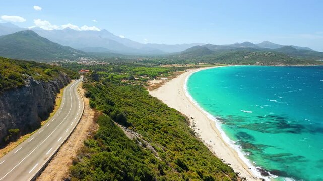 Plage de Lozari beach Corsica drone flight scenic coastal road long sand beach turquoise sea clear water near L Ile Rousse Balagne coast empty paradise Cinematic 4K aerial drone video