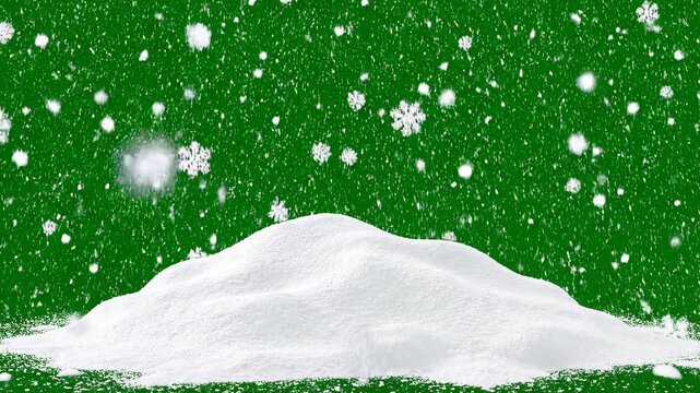 Gentle snowfall over snowy mounds during winter holiday celebration with festive green backdrop