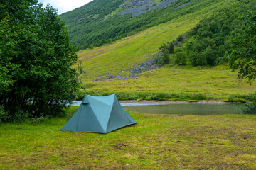 A beautiful green summer landscape with a tent near a river. A summer scenery of World Heritage Area in Western Norway. © dachux21